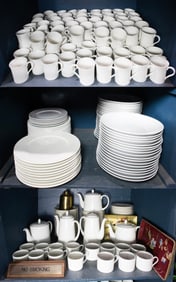 A large assembled white ceramic dinner service