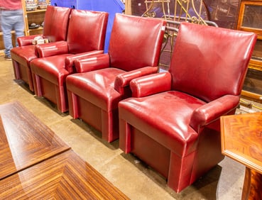 A set of four red faux leather upholstered dining armchairs, each with square back and rolled arms,