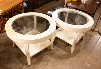 Two white painted glass top round tables with medial shelf
