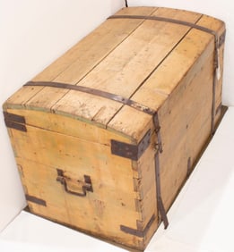 An antique pine chest with iron straps