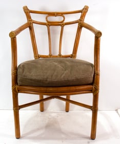 A rattan chair with pale green cushion