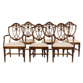 A suite of six hepplewhite style walnut dining chairs