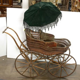 A Victorian wicker stroller with needlepoint upholstery