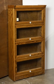 An oak four door barrister style bookcase