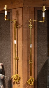 A pair of Contemporary brass wall light fixtures with swing arms