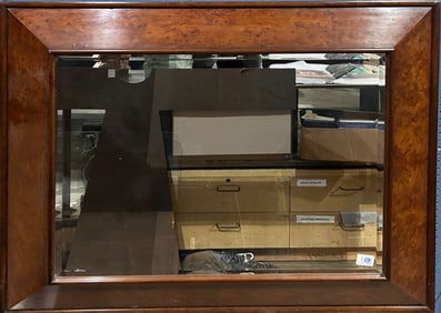 A large burlwood veneer beveled glass mirror