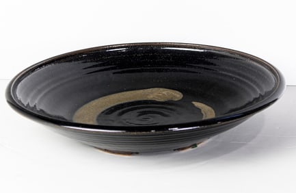 A Japanese black glazed charger