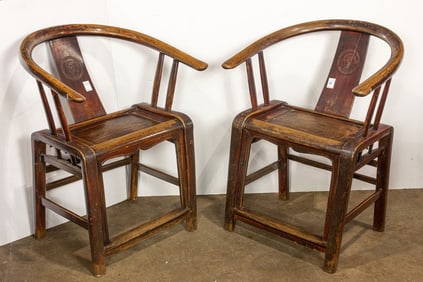 A pair of Chinese wood armchairs