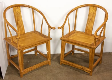 A pair of Chinese elm horseshoe-back armchairs
