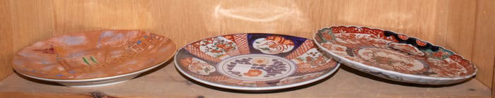 A shelf of Japanese Imari dishes and plates