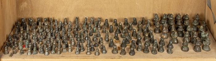 A shelf of Burmese bronze weights