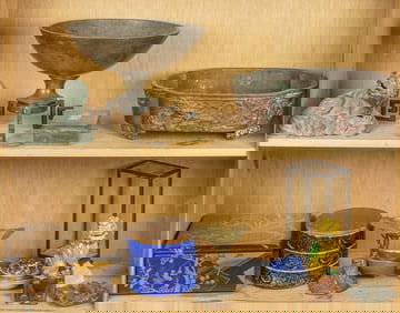 Two shelves of Asian decorative objects