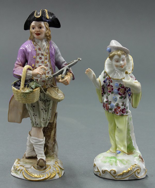 Meissen porcelain figures: (lot of 2) Meissen porcelain figures, one depicting a young boy dressed as a clown and rising on a naturalistic base 4.5"h, the other depicting a grape peddler, one arm holding a bushel of fruit, one 