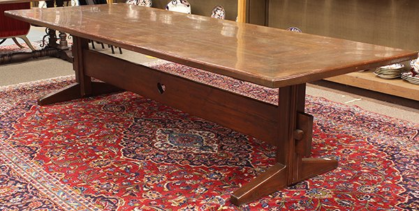 Arts and Crafts style dining table: Arts and Crafts style dining table, having a rectangular top above a trestle base with a keyed thru tenon plank stretcher centered with a heart cut outs and rising on shoe feet, 29"h x 10'l x 43"d