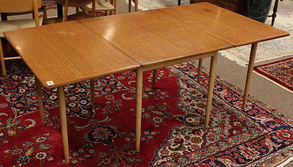 Mid century table: Mid century table, teak drop leaf in the style of Hans Wegner having eight round tapered legs. 28"h. x 74"w. (when fully extended) x 39"d.