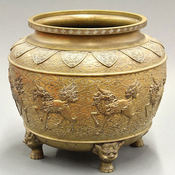 Japanese Large Bronze Censer: Japanese bronze tripod censer, cast with eight kirin on a cloud scroll ground, below a lappet band at the shoulder with stylized phoenixes, all raised on lion head supports, 13.5"h x 15" dia