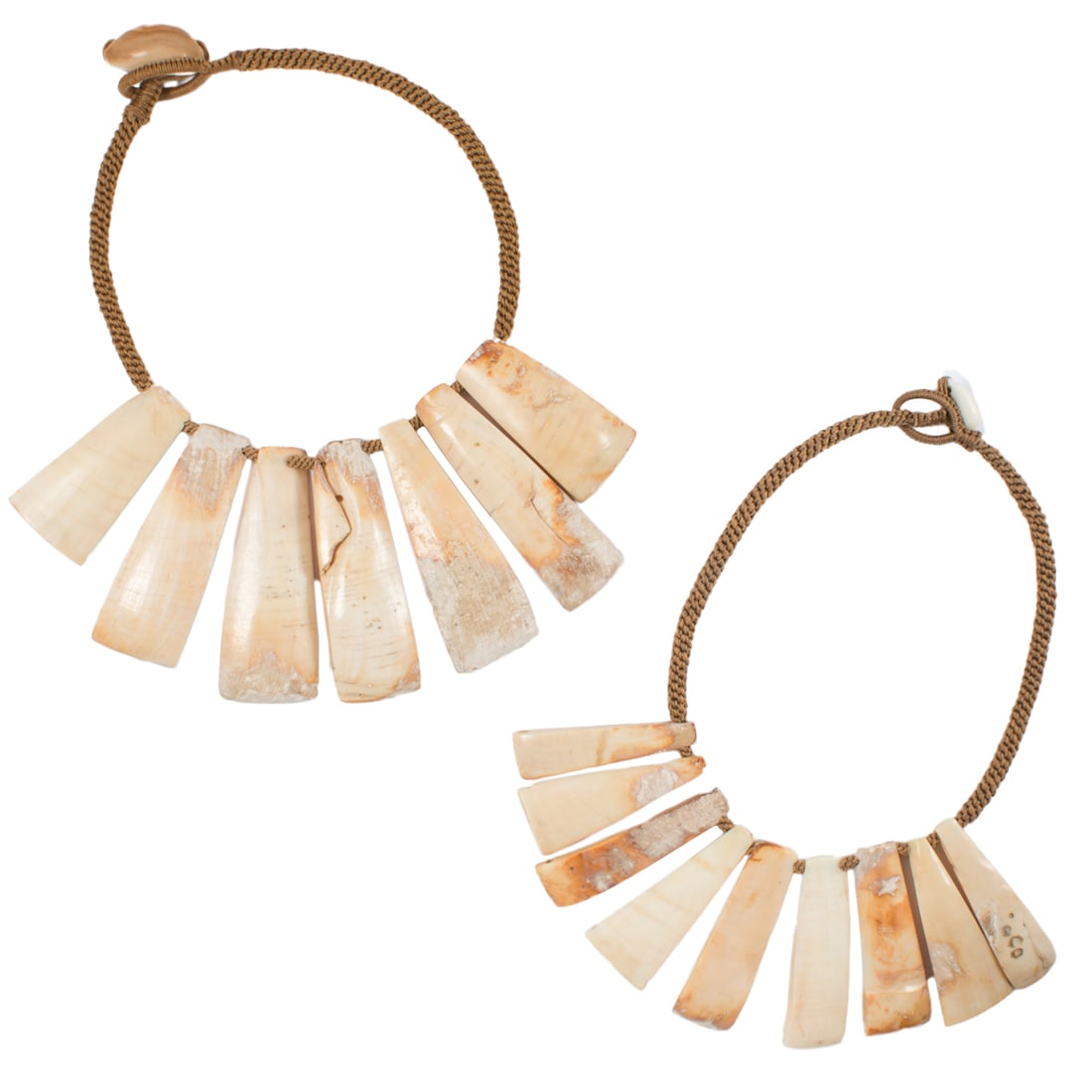 A group of Pre-Columbian mollusk shell struts: A group of Pre-Columbian mollusk shell struts. Strung as two necklaces, possibly from Northern Peru, from 2.125" to 3.25" long. Provenance: Naomi Lindstrom