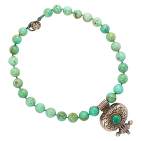 A Tibetan turquoise bead necklace and silver gau box