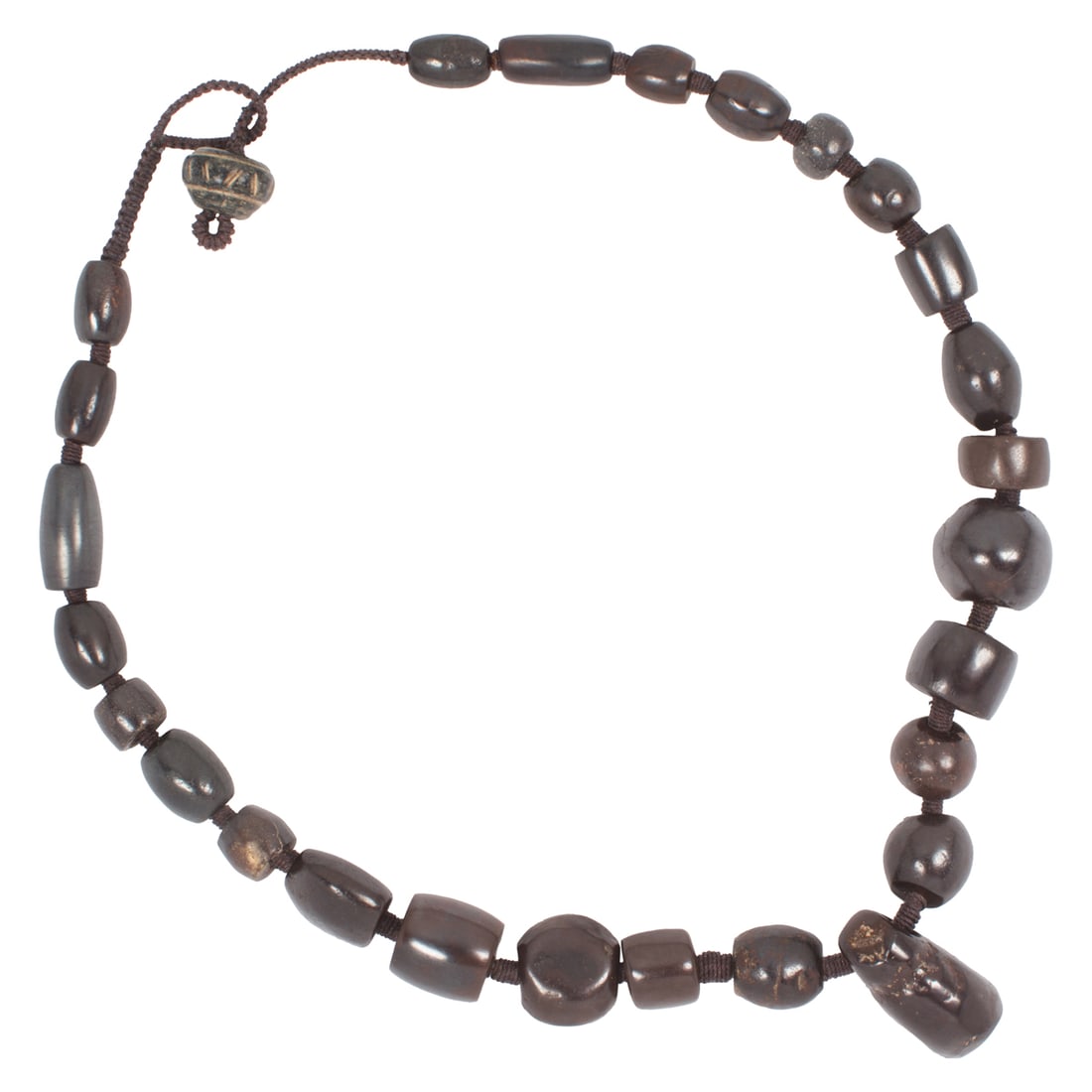 An strand of ancient hematite beads from Afghanistan: An strand of ancient hematite beads from Afghanistan. Strung as a necklace, 17" long. Provenance: Naomi Lindstrom