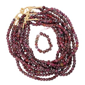 Nine strands of antique Venetian red skunk eye glass trade beads
