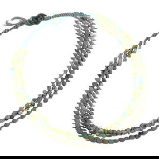 A triple-strand of Pathian faience beads: A triple-strand of Pathian faience beads. Strung as a necklace with beads of various colors and sizes, 0.125" to 0,374" wide. Provenance: Naomi Lindstrom