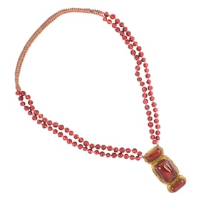 A Chinese glass bead necklace and glass inlaid bronze belt buckle