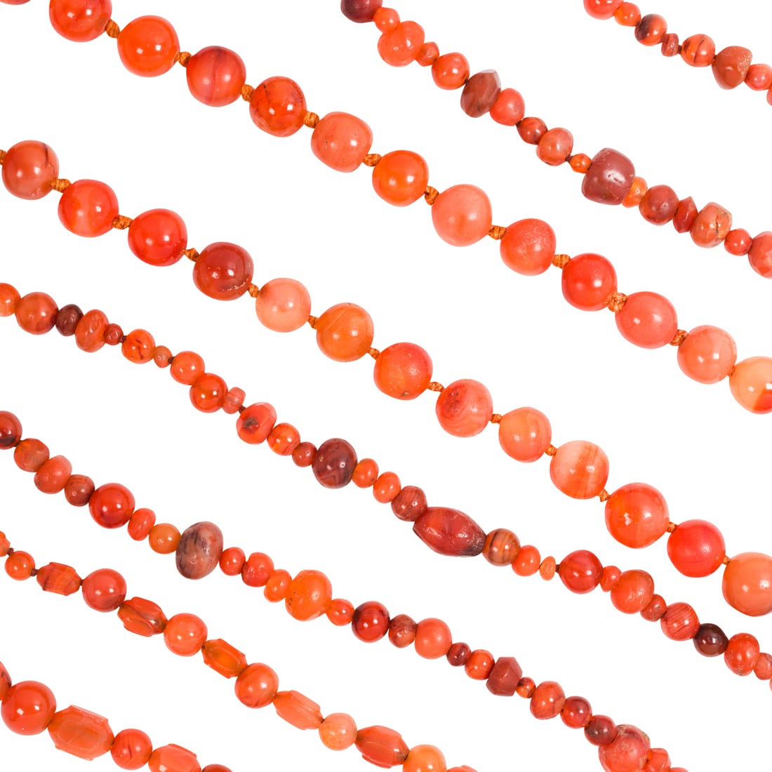 Four strands of Asian carnelian bead necklaces: Four strands of Asian carnelian bead necklaces. From 29" to 37" long. Provenance: Naomi Lindstrom