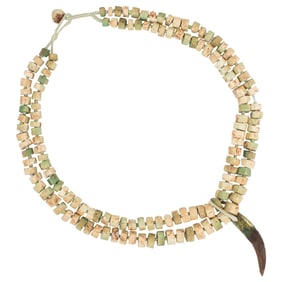 A Chinese Han dynasty fossil bone beads strung as necklace with a tusk