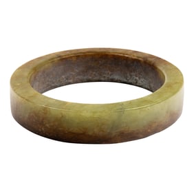 A Chinese mottled celadon jade bangle bracelet