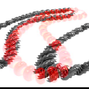 An exceptionally rare Tibetan red coral bead necklace: An exceptionally rare Tibetan red coral bead necklace. Comprising 41 graduated deep-red circular coral beads with alternating gilt silver spacers, 19th century or earlier, 22" long, 365 grams of total