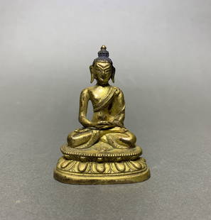 A Gilt Bronze Figure of Buddha Shakyamuni: A gilt-bronze figure of Buddha Shakyamuni. 2.66"h x 1.97"d (6.75 x 5 cm) Note: THIS ITEM IS IN LOS ANGELES.