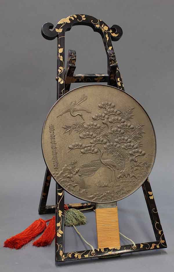 Japanese Bronze Mirror with Lacquer Stand: (lot of 2) Japanese bronze mirror cast with two cranes, a tortoise, bamboo and pines, the left center with the name Nishimura Bungo Jo Fujiwara Masashige (Edo period), the handle wrapped in bamboo str