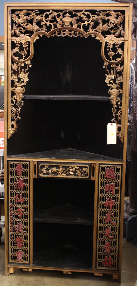 Chinese Wooden Corner Cabinet/Altar: Chinese gilt and lacquered wooden corner cabinet/altar, the upper section with a gilt frame pierced with bats, birds and vases with flowers, above the lower section flanked by a pair of seven characte