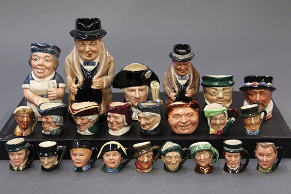 Royal Doulton character mugs and Toby jugs: (lot of 23) Royal Doulton porcelain small and miniature character mugs including Oliver Twist, Sam Weller, Beefeater, Dick Turpin, David Copperfield, John Barleycorn, Uriah Heep, Granny; together with