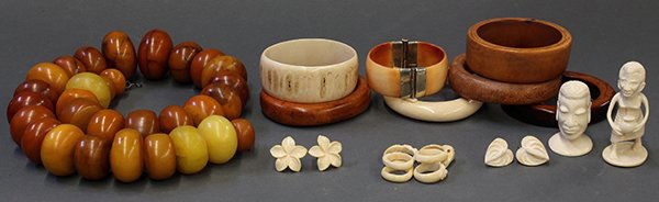 African ivory and Copal jewelry: (lot of 20) African ivory and Copal (amber) jewelry, including a strand of chunky trade beads, ivory rings, bracelets, earrings, figures, and wooden bangles