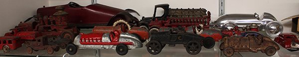 Antique cast iron toy group: (lot of 17) Antique cast iron toy group consisting of open racers including Hubley Kiddie, an aluminum racer, Kenton fire truck pumper, closed car sedans, delivery trucks, passenger trucks, etc.