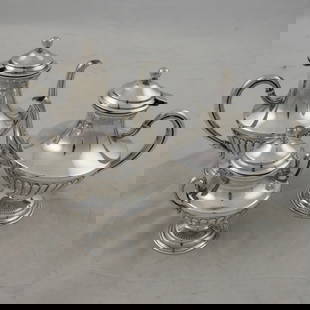 A three piece 800-standard silver tea and coffee service: A three piece 800-standard silver tea and coffee service, comprising a diminutive coffee pot, 7.25"h; a diminutive tea pot, 6.75"h; and a covered sugar, 5"h. 36.9 troy oz