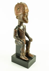 A Baule seated male figure with headdress