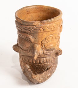 A Mayan plumbate cup depicting a bearded head