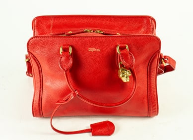 An Alexander McQueen red leather top handle bag wtih gold tone hardware and skull