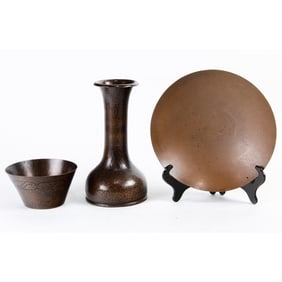 A group of three Arts and Crafts hammered copper vessels