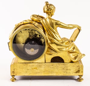 A Louis XVI style gilt bronze figural mantel clock