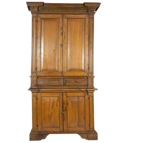 A French four door cabinet in two parts, each with hand hewn paneled fronts and centered by two