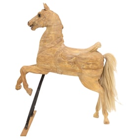 A wood carousel horse with horsehair tail and glass eyes, raised on stand