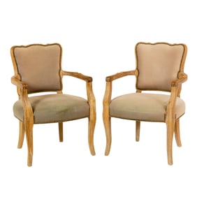 A pair of fauteuils with cerused wood frames upholstered in a grey herringbone fabric