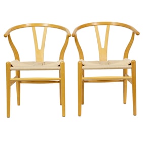 A pair of wishbone style arm chairs