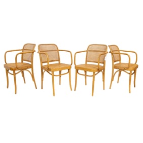 A suite of four Thonet arm chairs with cane seats