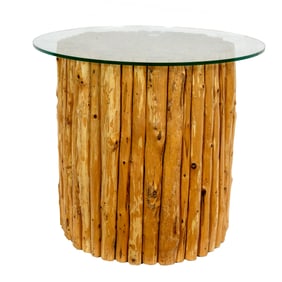 A contemporary glass top side table with wood branch base