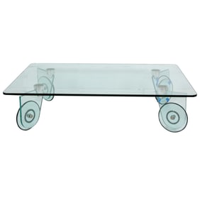 An Italian glass coffee table raised on glass casters