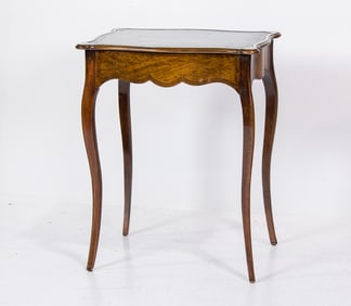 A Louis XV style side table with leather inset top by Sohon New York